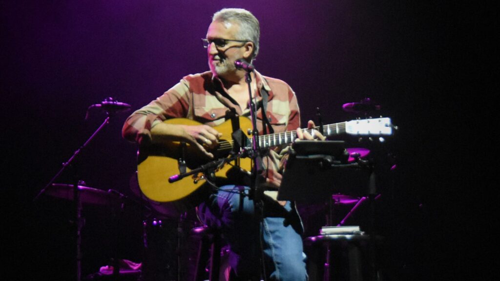 Steve Bell on stage with guitar